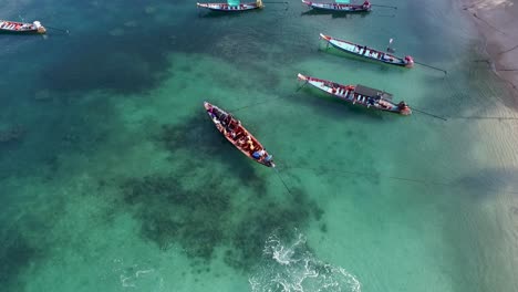 Longtail-boat-turn-around-with-people-camera-follow-from-above
