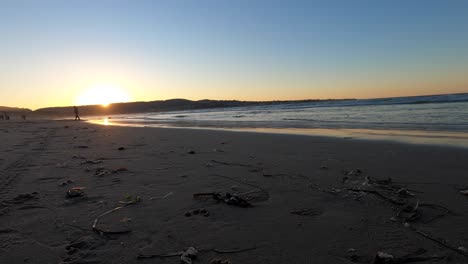 California-Sunset-over-Carmel-Beach---Still-shot-of-the-waves-rolling-up-4K