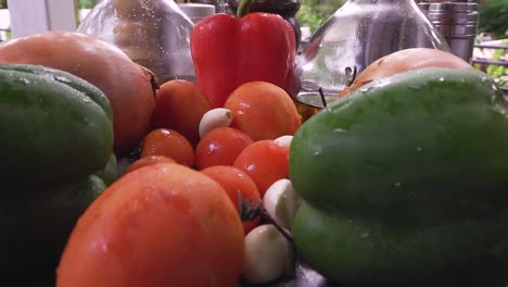 Camera-move-back-between-colorful-vegetables-on-kitchen-table-close-up