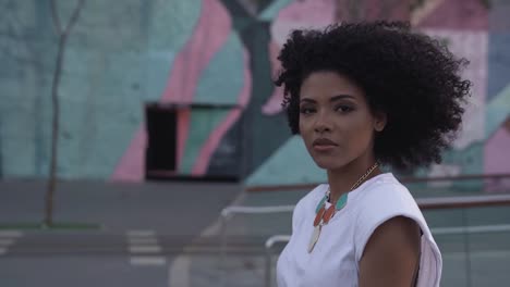 Black-Afro-Brazilian-Woman-Walking-And-Making-Eye-Contact,-Slow-Motion,-Close-Up
