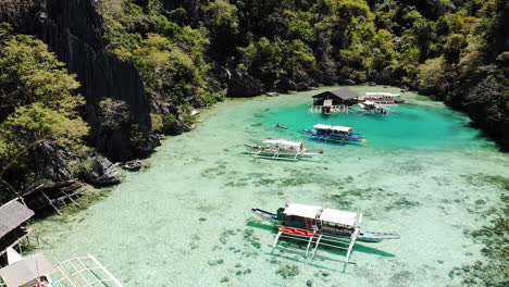 Laguna-Azul-Con-Botes-De-Cola-Larga-Junto-Al-Lago-Karangan-En-Coron-Palawan