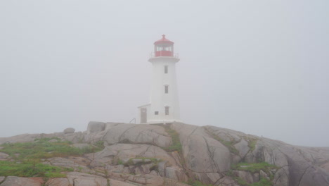 The-Peggy's-Cove-Lighthouse-in-Nova-Scotia,-Canada-during-a-foggy-morning