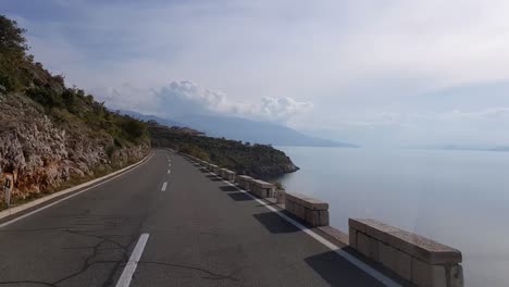 Conduciendo-Por-Una-Carretera-Costera-Con-Vistas-Al-Mar-En-Calma-En-Dalmacia,-Croacia