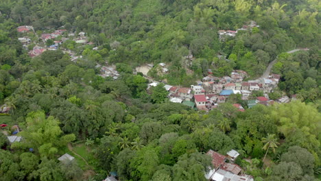 Drone-video-from-above-with-houses-built-in-green-jungle-in-a-third-world-country-1
