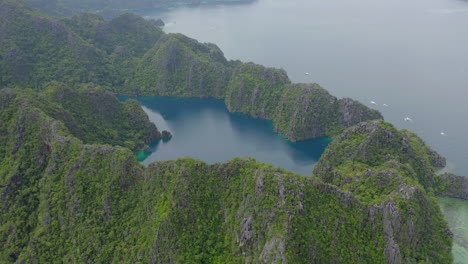 A-drone-shot-on-an-overcast-day-of-the-ocean-and-a-lake-in-the-mountains-in-the-Philippines