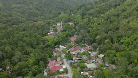 Drone-video-from-above-with-houses-built-in-green-jungle-in-a-third-world-country