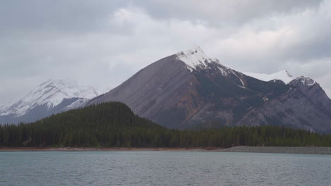 A-lonely-landscape-of-mountains-in-Kananaskis-Provincial-Park-in-Alberta,-Canada-during-a-windy,-overcast-afternoon