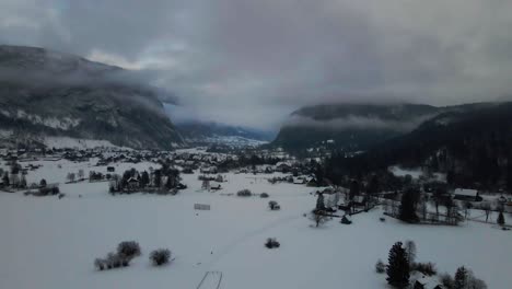 Aerial-View-of-Gloomy-Winter-Landscape-in-Mountain-Valley,-Snow-Capped-Fields-on-Cold-Day,-Drone-Shot