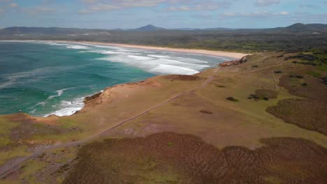 Aerial-view-over-the-Moonee-Beach-Nature-Reserve,-in-Australia---rising,-drone-shot