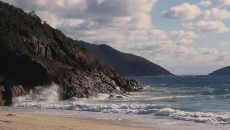 Slow-motion-shot-of-ocean-waves-crashing-against-rocks-on-beach-in-Newcastle-Port-Stephens-NSW-Australia-1920x1080-HD