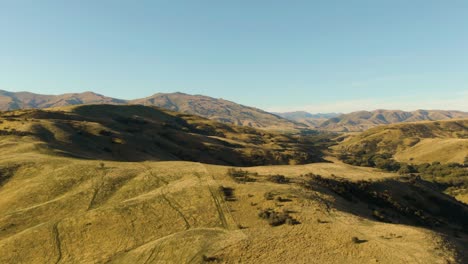 Drone-parallax-of-rolling-hillsides-during-golden-hour