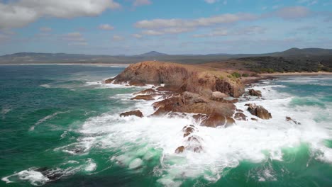 Aerial-drone-view-towards-the-cliffs-at-the-headland-bay-at-the-Moonee-Beach-Reserve