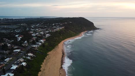 Drone-shot-over-morning-rural-coastal-town-with-houses-and-ocean-waves-at-sandy-beach-Forresters-Beach-Central-Coast-NSW-Australia-3840x2160-4K