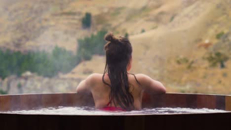 Girl-relaxing-in-cedar-tub-with-stunning-views