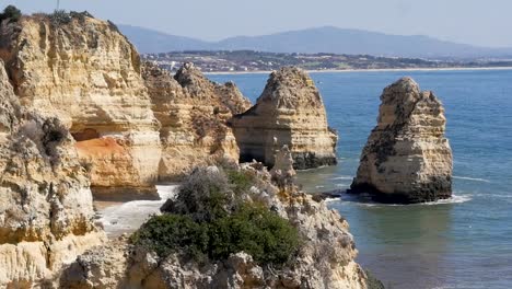 Slow-motion-still-shot-of-rocky-cliff-in-Lagos-beach-headland-Praia-do-Pinhão-Algarve-Portugal-Europe-1920x1080-HD