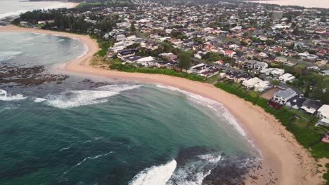 Drone-pan-shot-over-ocean-waves-on-reef-beach-in-coastal-Blue-Bay-suburb-of-the-Central-Coast-NSW-Australia-3840x2160-4K