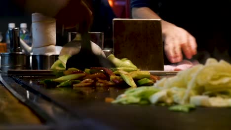 Chef-cooking-Teppanyaki-with-spatula-food-vegetables-on-heat-grill-in-Kyoto-Japan-1920x1080-HD