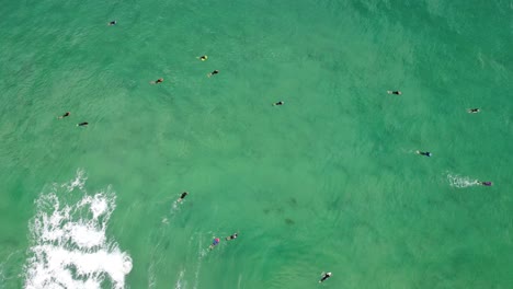 Bird's-eye-drone-shot-ocean-with-surfers-and-bodyboarders-in-waves-at-Lakes-Beach-Budgewoi-Central-Coast-NSW-Australia-3840x2160-4K