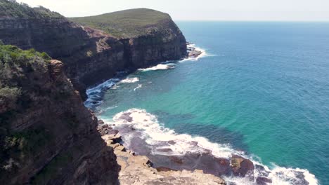 Drone-pan-coastline-shot-of-Bouddi-National-Park-headland-cliff-face-in-Little-Beach-Macmasters-Central-Coast-NSW-Australia-3840x2160-4K