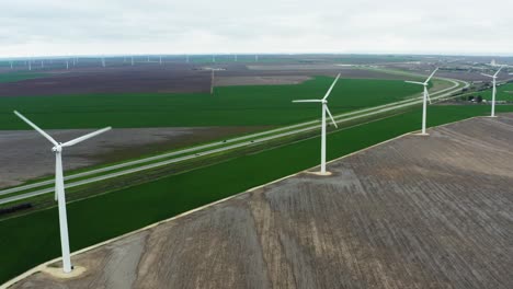 Wind-turbine-ecological-farm-on-highway-side-in-aerial-view