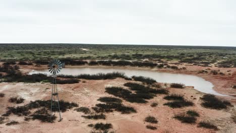 Lonely-unusable-windmill-lost-in-deserted-area-in-aerial-view