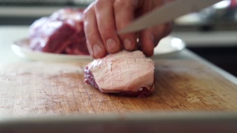 Scoring-fat-on-lamb-rump-meat-cut-with-sharp-knife