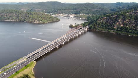 Drone-pan-shot-of-Hawkesbury-River-Bridge-freeway-with-cars-and-fishing-boats-in-Brooklyn-Hornsby-NSW-Sydney-Australia-3840x2160-4K