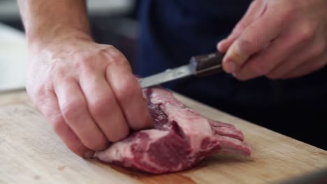 Chef-trimming-fat-of-large-rump-of-lamb