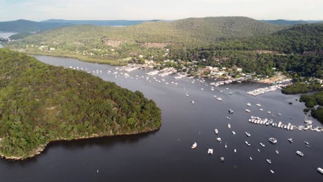 Drone-pan-shot-of-Brooklyn-Harbour-dock-with-boats-in-Bushland-of-Hawkesbury-River-NSW-Hornsby-Sydney-Australia-3840x2160-4K