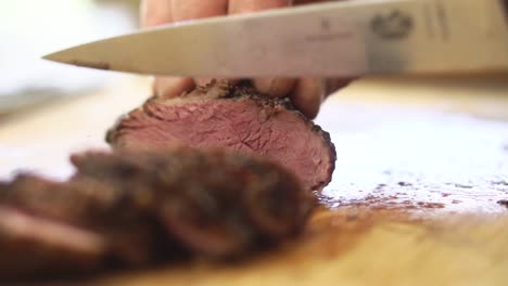 Close-up-slicing-of-lamb-on-chopping-board