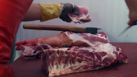 The-butcher-cleans-the-meat-from-excess-fat-and-tendons-with-knife