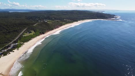 Drone-pan-scenic-nature-shot-over-Catherine-Hill-Bay-ocean-waves-at-beach-Swansea-NSW-Australia-3840x2160-4K