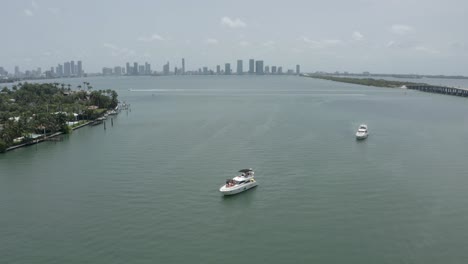 Aerial-view-of-luxury-cruiser-yacht-on-Biscayne-Bay-against-Miami-skyline