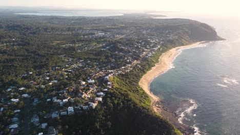 Drone-aerial-sky-pan-shot-of-coastline-Forresters-Beach-suburb-ocean-town-on-Central-Coast-NSW-Australia-3840x2160-4K