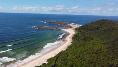 Drone-scenic-pan-view-of-Pacific-ocean-beach-coastline-with-bushland-and-sandy-beach-Moonee-Bay-Catherine-Hill-Bay-Swansea-NSW-Australia-3840x2160-4K