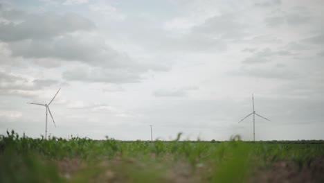 Clouds-over-wind-turbines-in-a-wind-energy-farm-in-Mexico,-low-angle-wide-shot