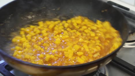 Shaking-pumpkin-risotto-to-mix-with-rich-sauce-while-cooking