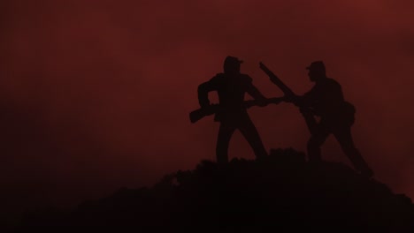 Two-toy-soldier-silhouettes-in-a-close-battle