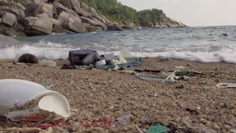 Plastic-and-mixed-rubbish-washed-out-from-sea-steady-shoot-4K-Asia,-Thailand-Filmed-with-Sony-AX700