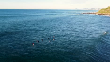 Drone-aerial-scenic-shot-of-surfers-waiting-in-line-up-Pacific-Ocean-Central-Coast-NSW-Australia-3840x2160-4K
