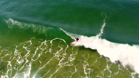 Drone-aerial-shot-of-malibu-longboard-surfer-on-ocean-wave-surfing-at-Terrigal-Beach-NSW-Central-Coast-Australia-3840x2160-4K