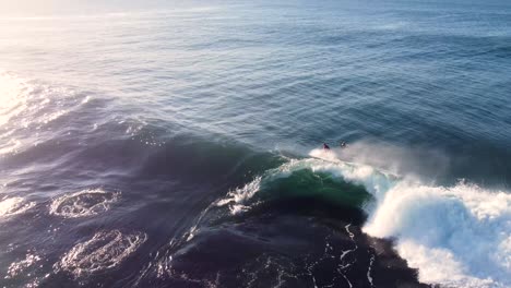 Drone-aerial-videography-of-surfer-riding-barrel-wave-with-spit-on-reef-Pacific-Ocean-Central-Coast-NSW-Australia-3840x2160-4K