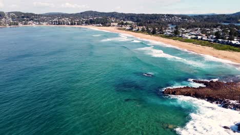 Drone-aerial-pan-shot-of-landscape-scenic-North-Avoca-Beach-tourism-Central-Coast-NSW-Australia-4K