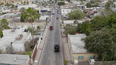 Aerial-follow-of-SUV-on-streets-of-El-Medano,-Cabo-San-Lucas,-Mexico