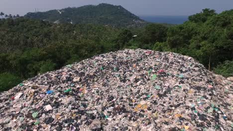 A-big-mountain-of-rubbish-between-trees-Thailand-1080-HD-Asia,-Thailand-Filmed-with-Sony-AX700