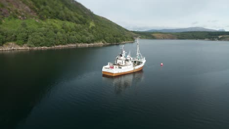 An-orbit-shot-of-a-fishing-ship-anchored-in-the-fjord