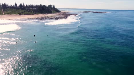 Drone-aerial-sky-view-of-scenic-coastline-with-surfers-on-Shelly-Beach-Toowoon-Bay-Central-Coast-tourism-NSW-Australia-3840x2160-4K