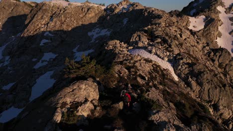 Epic-aerial-view-of-hikers-on-a-ridge-in-British-Columbia-alpine-backcountry-at-sunset