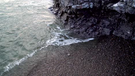 Waves-lapping-against-rocks-of-cliff-at-high-tide