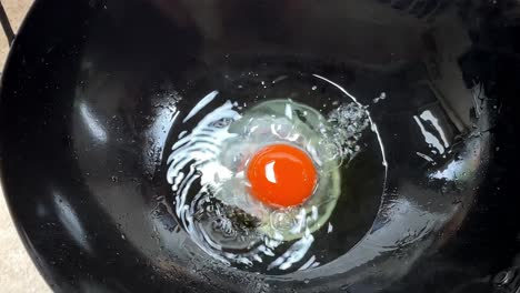 Chef-pouring-egg-in-hot-pan-for-cooking